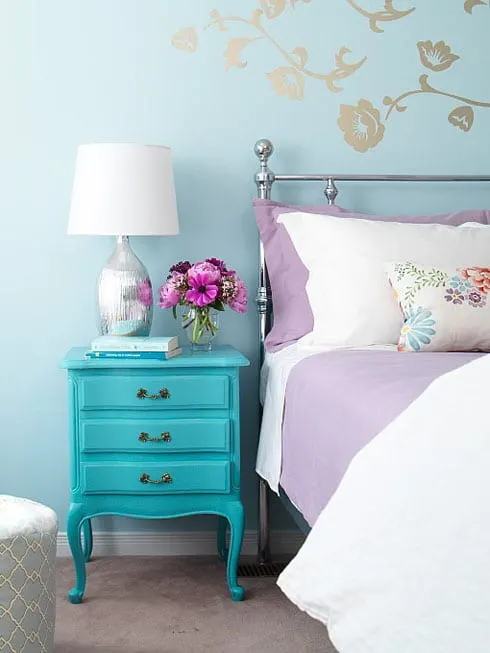 turquoise-bedroom-walls-silver-lamp-diy-painted-nightstand-purple-bedding-floral-throw-pillow