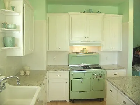 vintage-kitchen-jade-green-stove-white-cabinets-granite-countertops