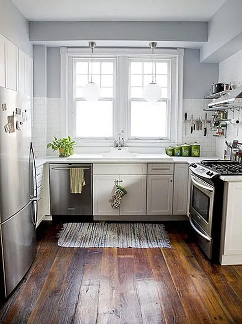 white-kitchen-cabinets-subway-tile-stainless-steel-appliances-blue-walls-plank-wood-floors