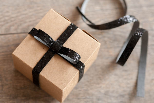 Curly, glittery green ribbon for gift wrapping on a white