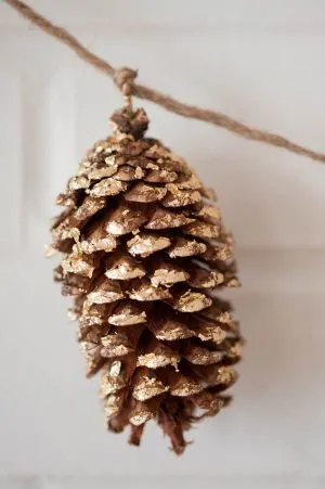 DIY gold leaf pine cone garland from The Sweetest Occasion | Photo by Alice G Patterson