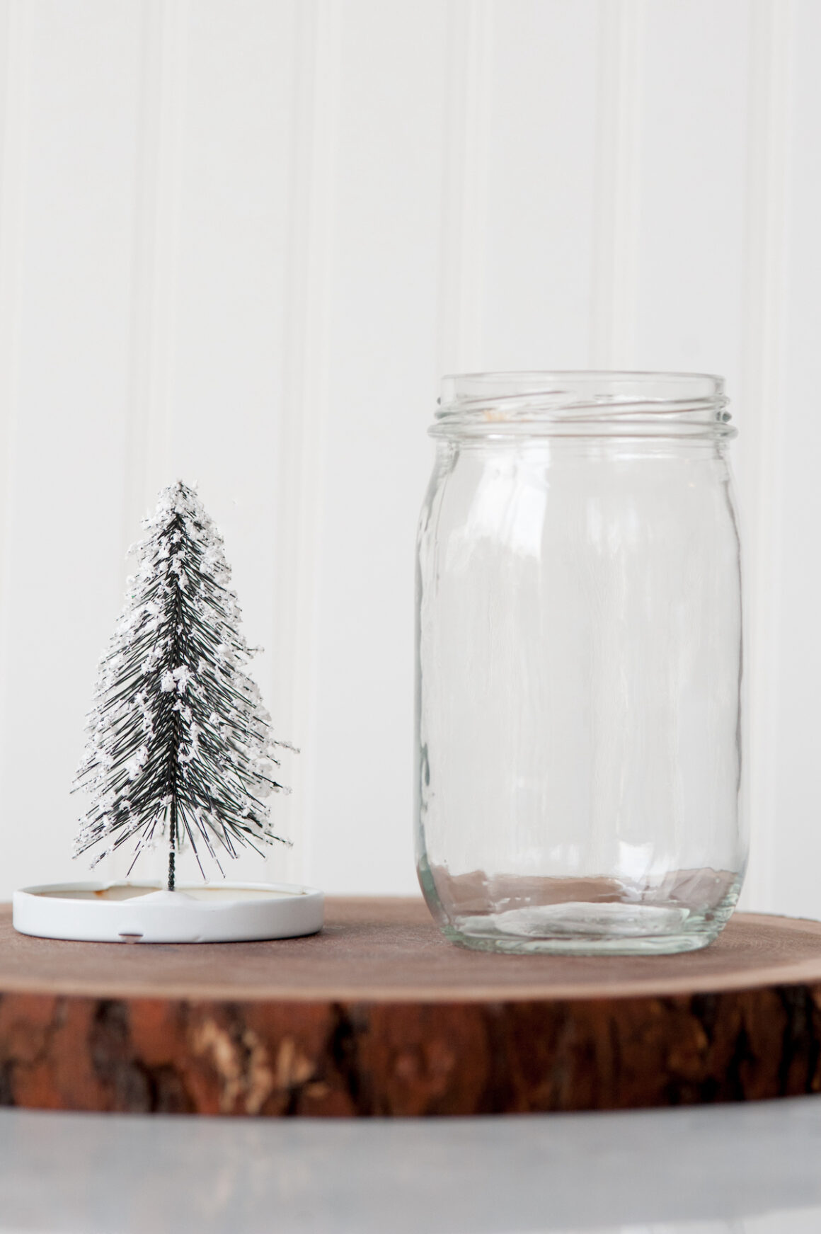 Empty mason jar alongside a miniature tree - snow globe supplies