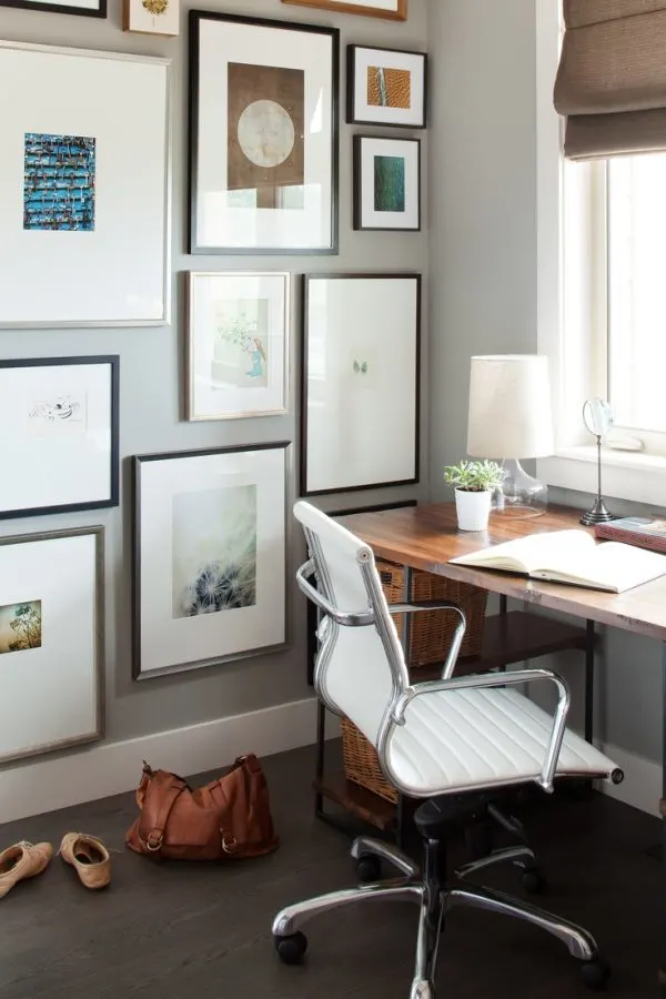 Office with gallery wall and warm wood floors