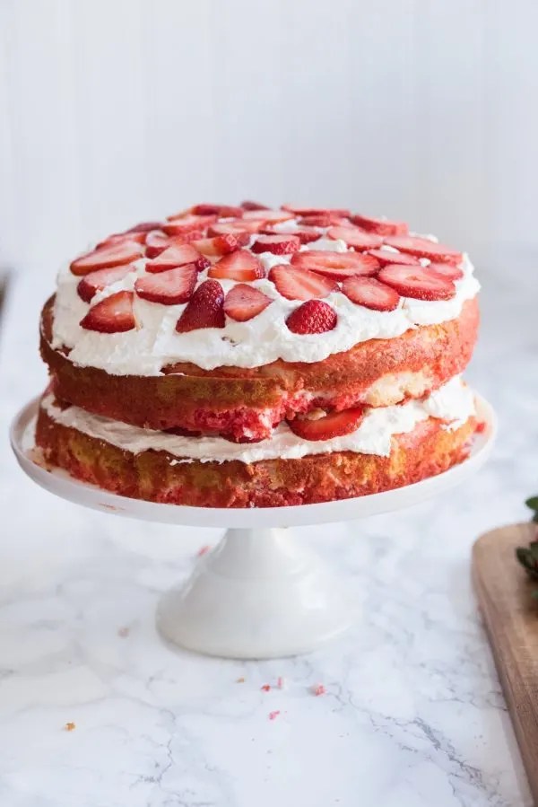 Strawberry Poke Cake with Berries + Cream | Birthday cake recipes, poke cake recipes, party appetizers, entertaining tips, birthday party ideas and more from @cydconverse