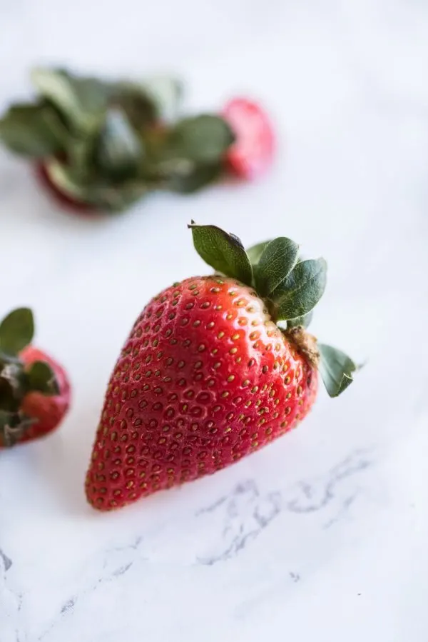 Strawberry Poke Cake with Berries + Cream | Birthday cake recipes, poke cake recipes, party appetizers, entertaining tips, birthday party ideas and more from @cydconverse