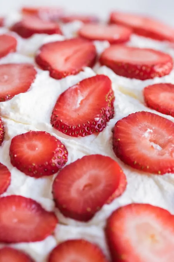 Strawberry Poke Cake with Berries + Cream | Birthday cake recipes, poke cake recipes, party appetizers, entertaining tips, birthday party ideas and more from @cydconverse