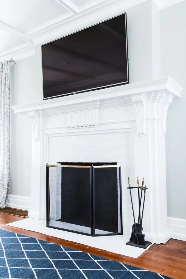 A Budget-Friendly DIY Fireplace Makeover for Under $30 | Easy home reno projects, fireplace ideas, tips for how to paint a fireplace and how to paint brick from @cydconverse