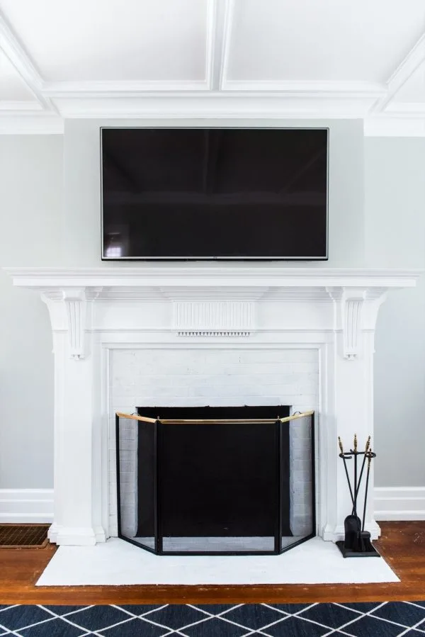 A Budget-Friendly DIY Fireplace Makeover for Under $30 | Easy home reno projects, fireplace ideas, tips for how to paint a fireplace and how to paint brick from @cydconverse