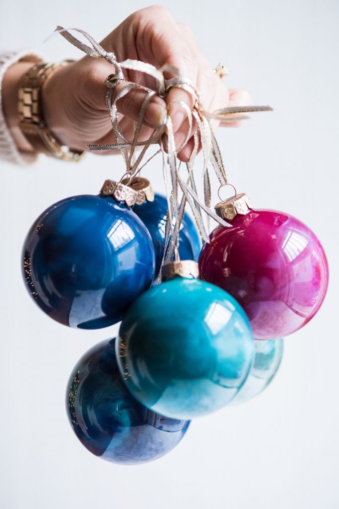 DIY Swirled Melted Crayon Ornaments | DIY ornaments, holiday entertaining tips, holiday cocktail recipes, homemade ornaments and more from @cydconverse