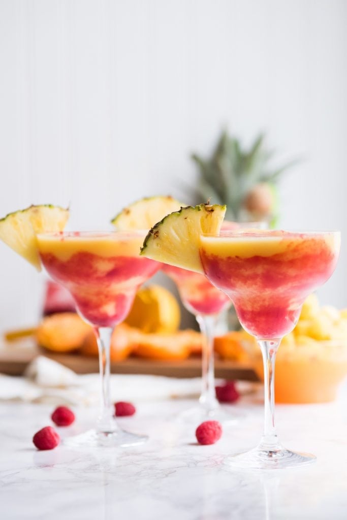 Raspberry Swirl Pineapple Mango Margaritas | Entertaining tips, cocktail recipes, party recipes and more from @cydconverse