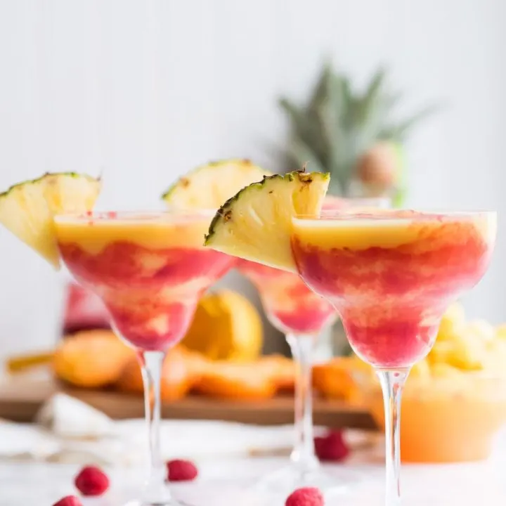 Raspberry Swirl Pineapple Mango Margaritas | Entertaining tips, cocktail recipes, party recipes and more from @cydconverse