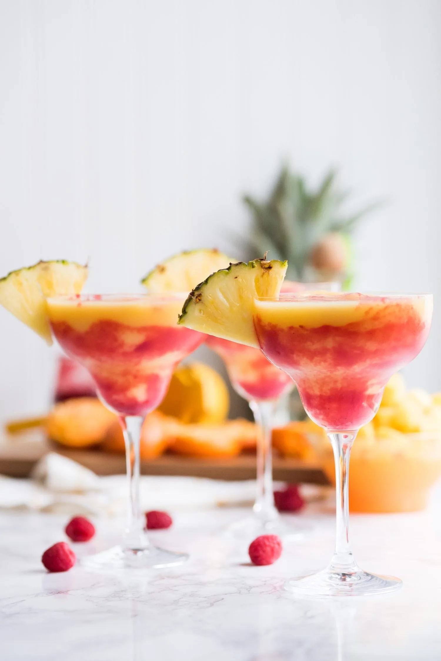 https://thesweetestoccasion.com/wp-content/uploads/2018/05/raspberry-pineapple-mango-frozen-margarita-recipe-12.jpg.webp