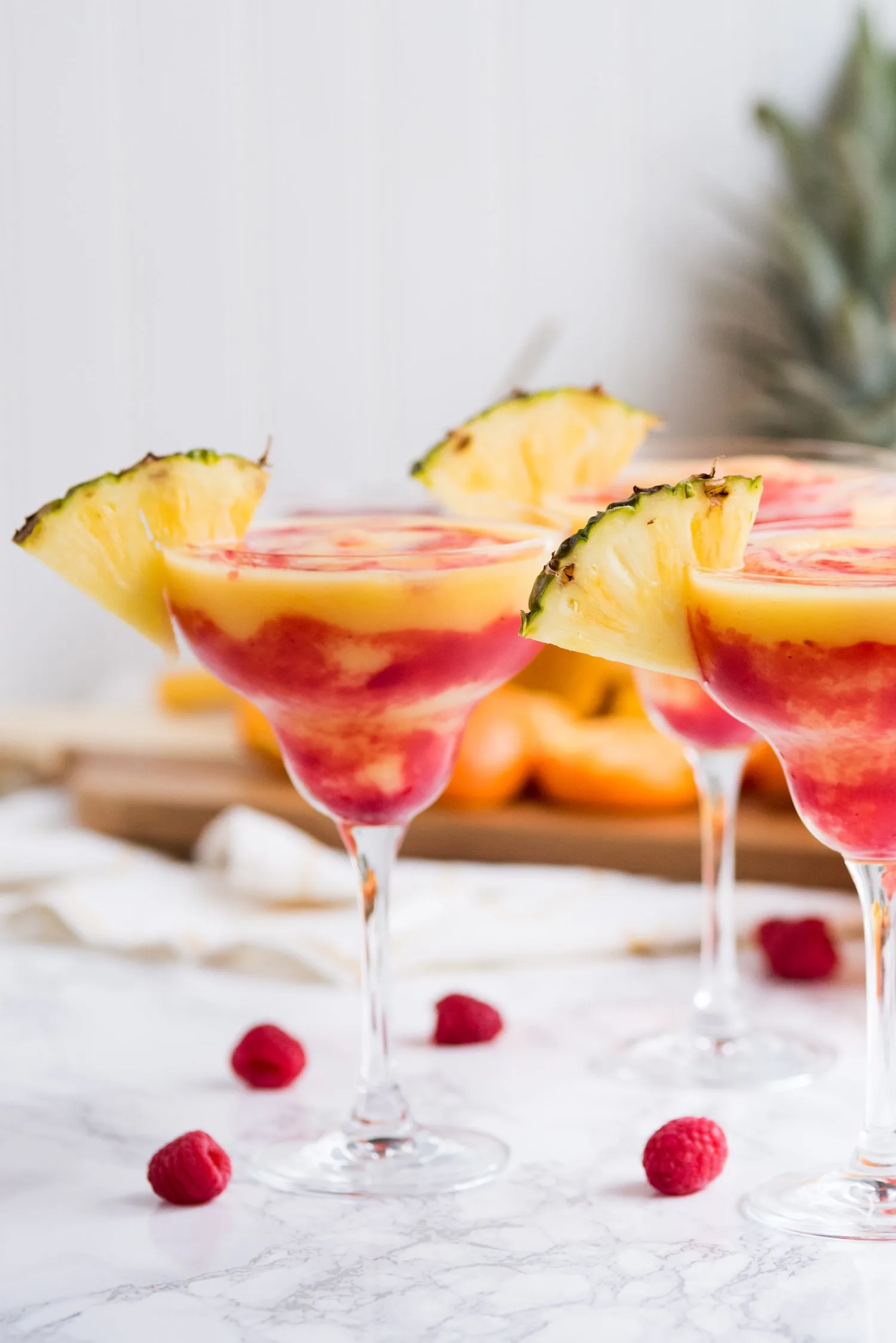 Raspberry Swirl Pineapple Mango Margaritas | Entertaining tips, cocktail recipes, party recipes and more from @cydconverse