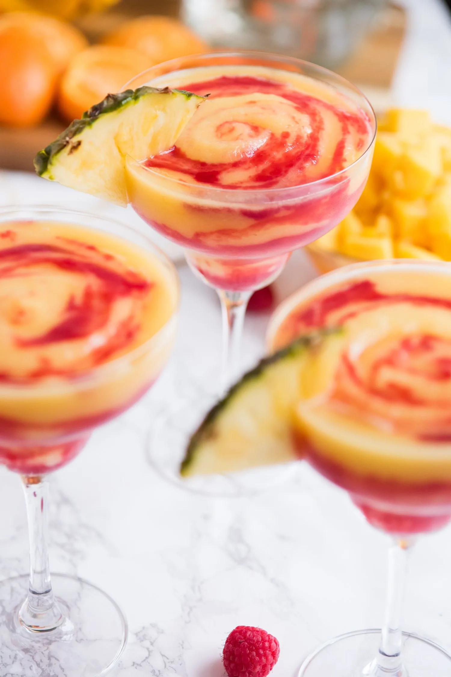 Raspberry Swirl Pineapple Mango Margaritas | Entertaining tips, cocktail recipes, party recipes and more from @cydconverse