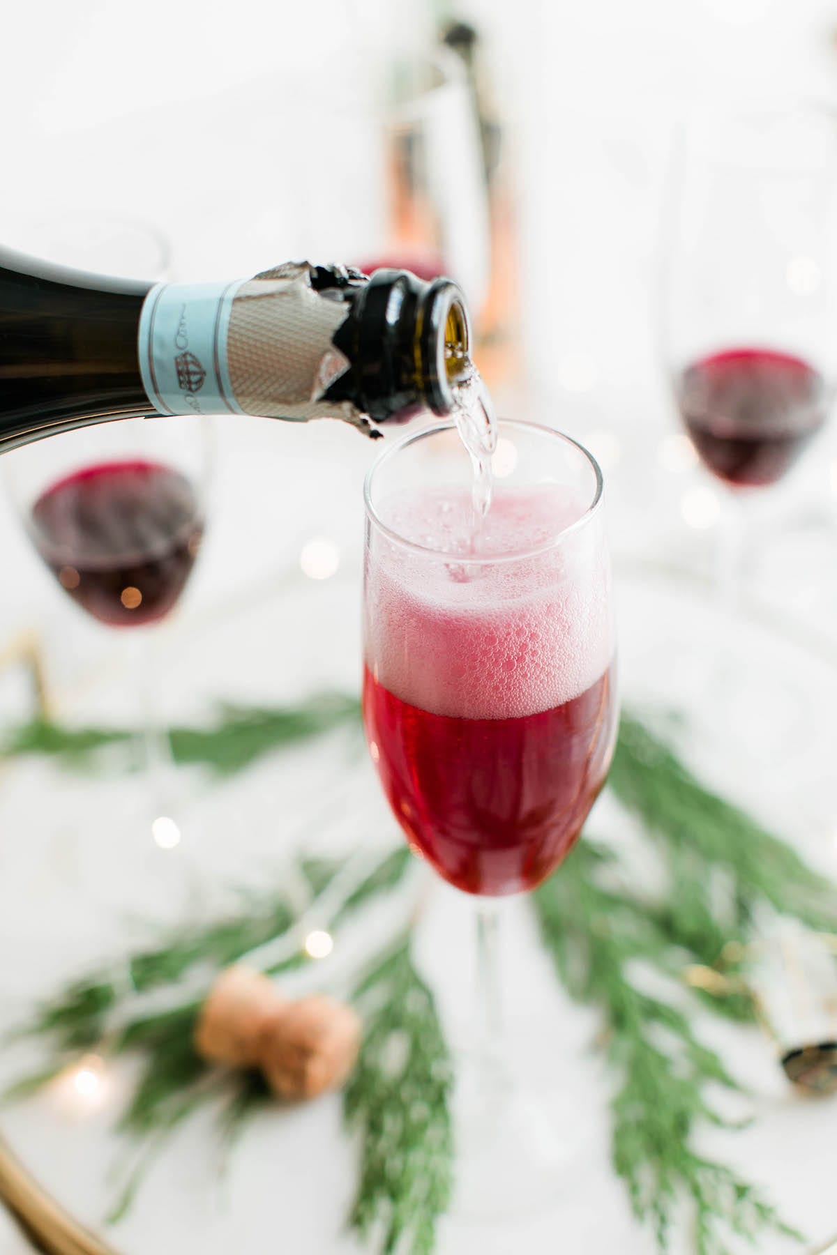 Champagne cocktails make the best Christmas cocktails! This blueberry bubbly sparkler is the perfect Christmas cocktail recipe. See more from entertaining blog @cydconverse!