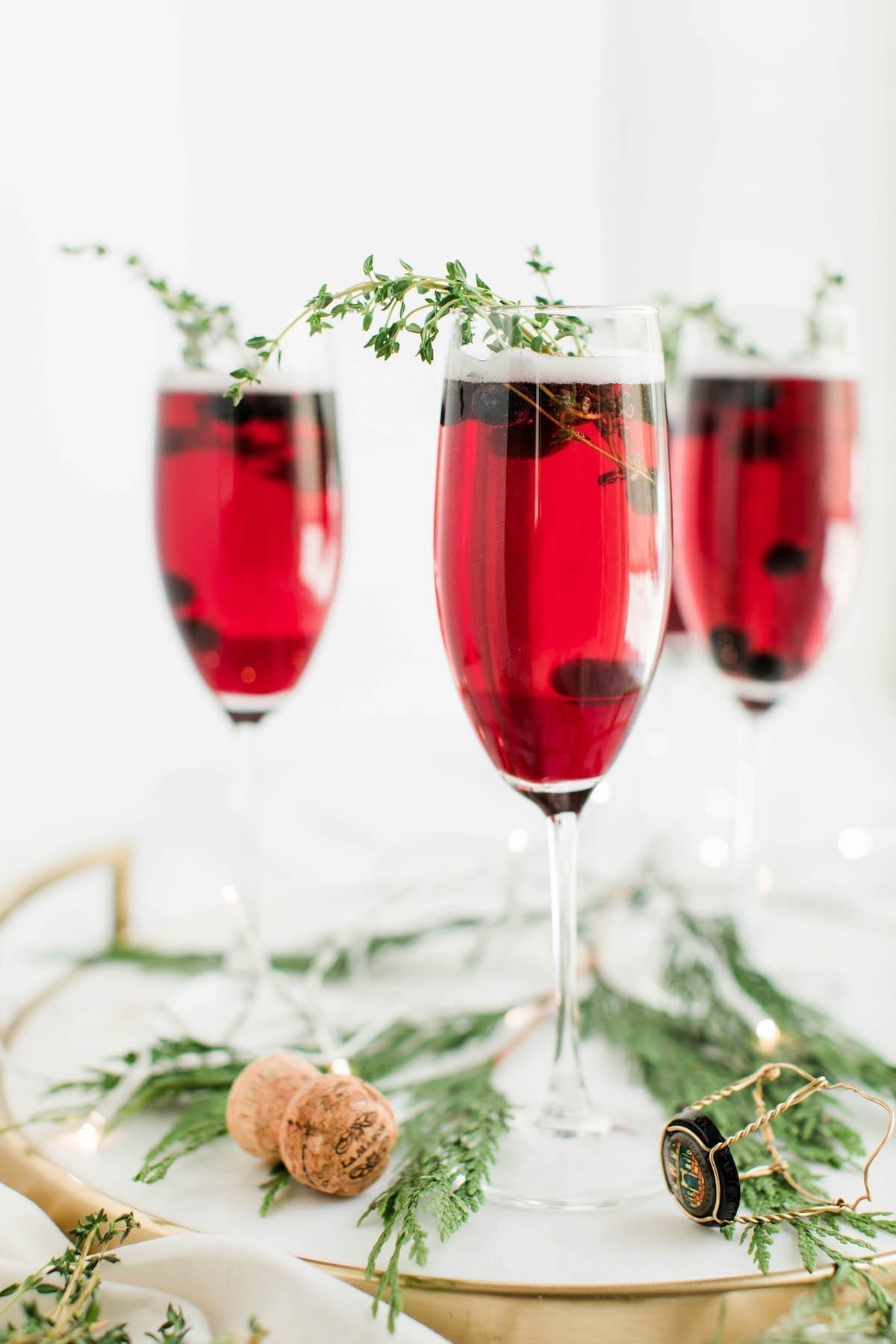 Champagne cocktails make the best Christmas cocktails! This blueberry bubbly sparkler is the perfect Christmas cocktail recipe. See more from entertaining blog @cydconverse!