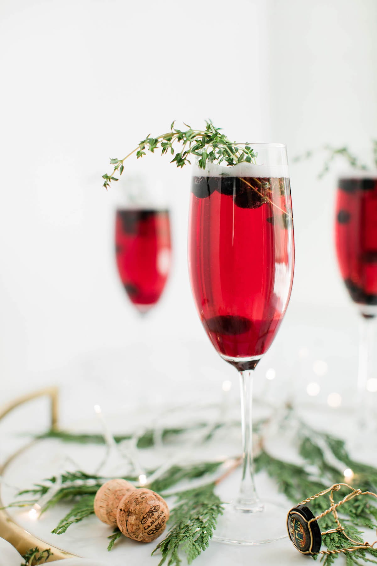 Champagne cocktails make the best Christmas cocktails! This blueberry bubbly sparkler is the perfect Christmas cocktail recipe. See more from entertaining blog @cydconverse!